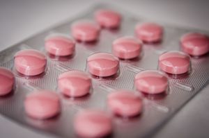 Pink tablets in a blister pack, emphasizing healthcare and medication concepts.